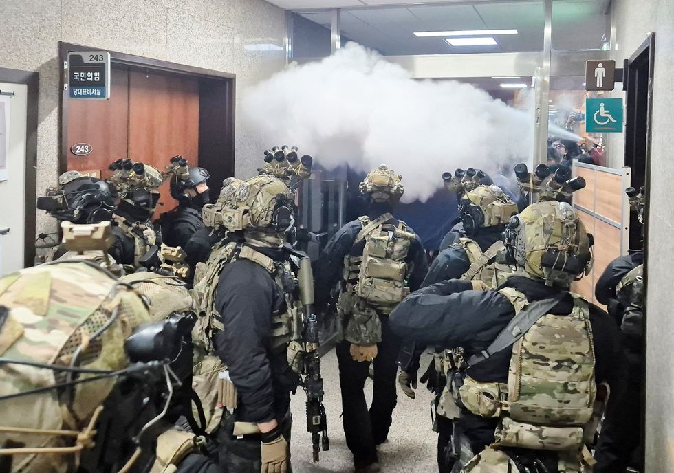 Soldiers advance to the main building of the National Assembly as South Korean President Yoon Suk Yeol declares martial law