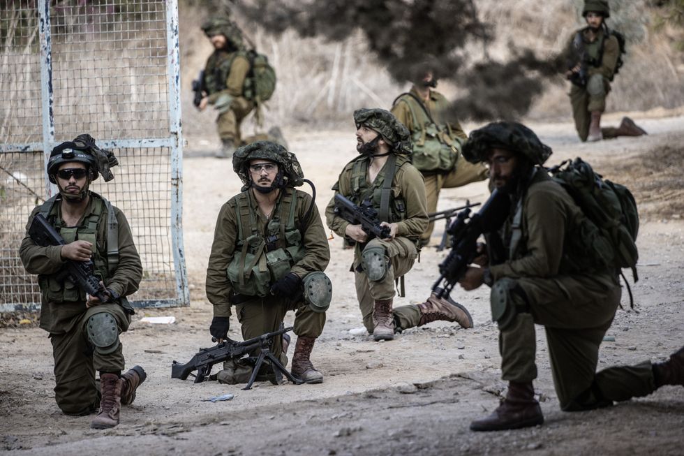 Soldiers of Israeli army patrol in Kfar Aza settlement of southern Israel near Gaza border