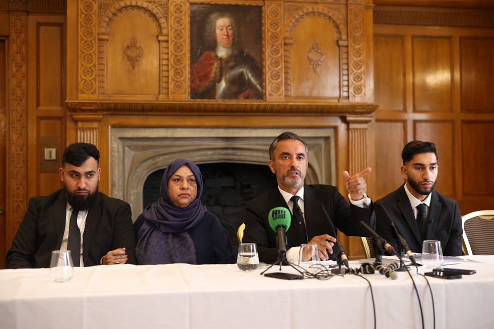 Solicitor Aamer Anwar (2-R) gestures as he accompanies brothers Muhammad Amaad (L), Fahir Amaaz (R) and their mother, Shameem Akhtar (2-L), during a press conference at the Midland Hotel on August 6, 2024