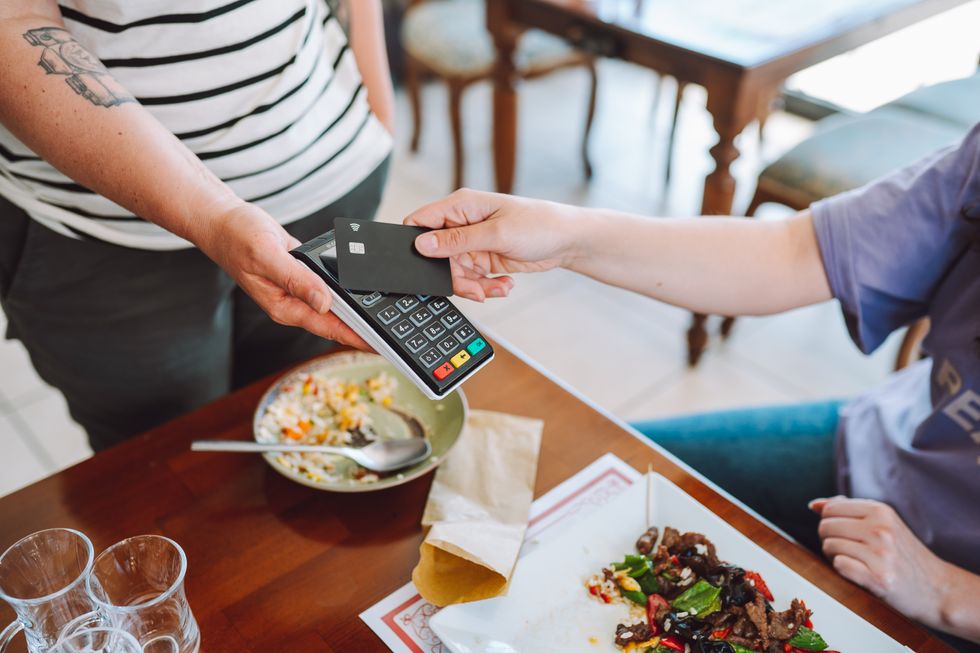 Someone paying their bill at a restaurant