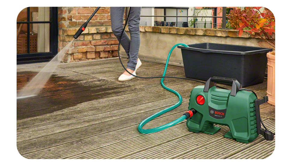 someone uses the bosch pressure washer to clean wooden flooring with high pressure water