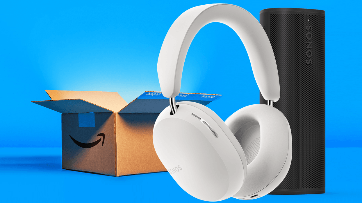 sonos ace headphones pictured in the foreground next to the sonos roam 2 portable speaker with a prime day shipping box in the background