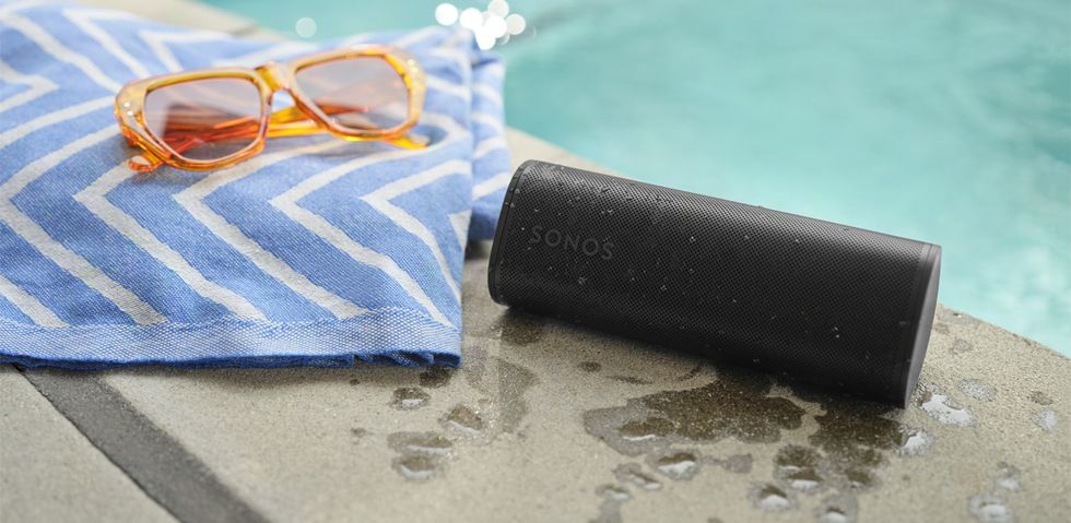 Sonos Roam 2 covered in water droplets by the side of the pool