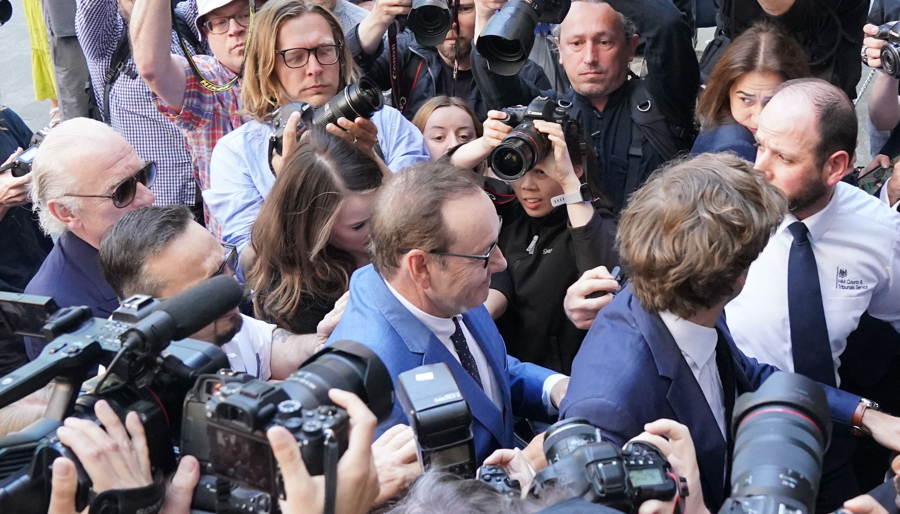 Spacey was mobbed outside court