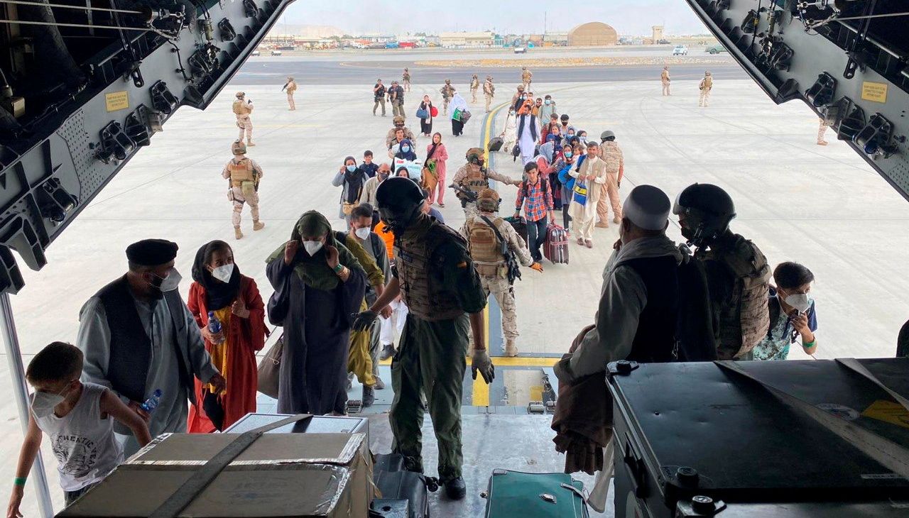 Spanish citizens residing in Afghanistan and Afghans board a military plane as part of their evacuation, at the Hamid Karzai International Airport in Kabul, Afghanistan, August 18, 2021.