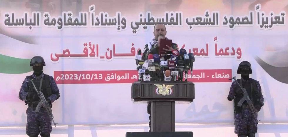 Speakers in Yemen are flanked by armed guards