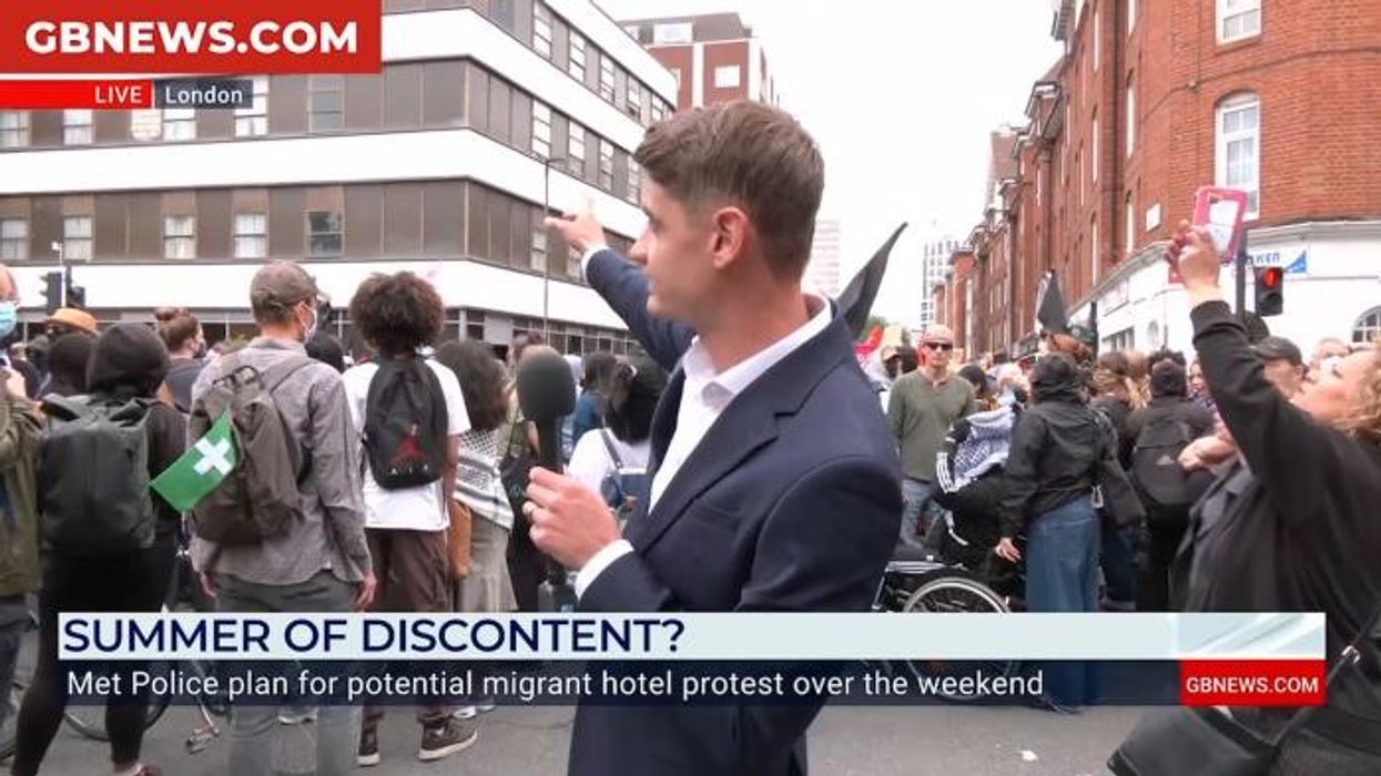 Moment courageous Briton proudly holds Union Jack flag aloft in front of mask-clad Antifa protesters