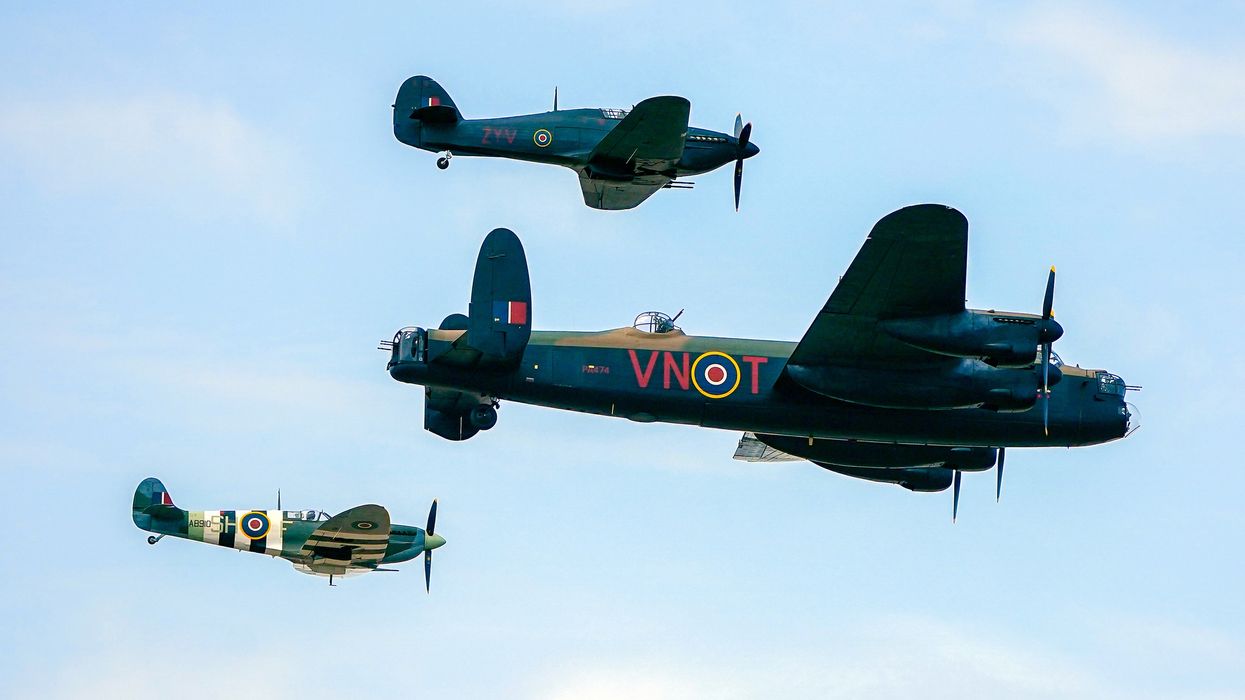 Spitfire, a Hawker Hurricane, and a Lancaster bomber, part of the Battle of Britain Memorial Flight, during the annual Southport Air Show at Southport beach in Merseyside