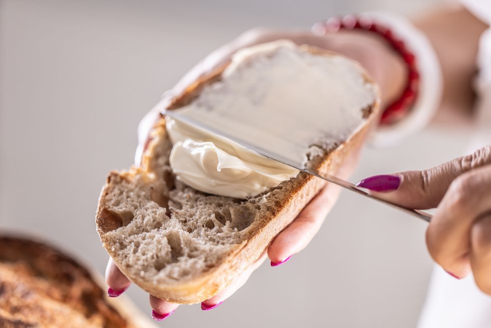 Spreading margarine on toast