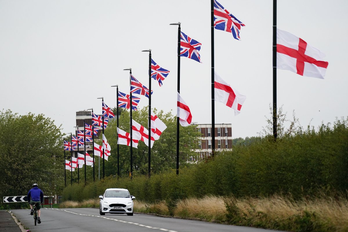 St George's and Union Flags fly by a roadside