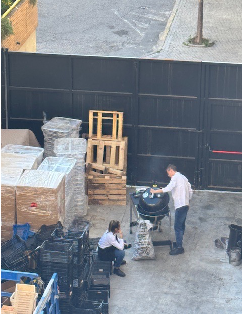Staff workers at a hotel heat up the barbeque