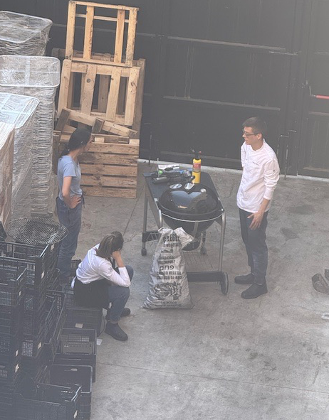 Staff workers at a hotel heat up the barbeque