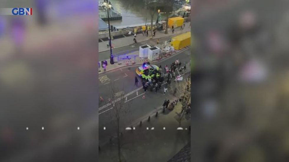 Police officers step in to protect Keir Starmer after group protesting against Covid measures follow him