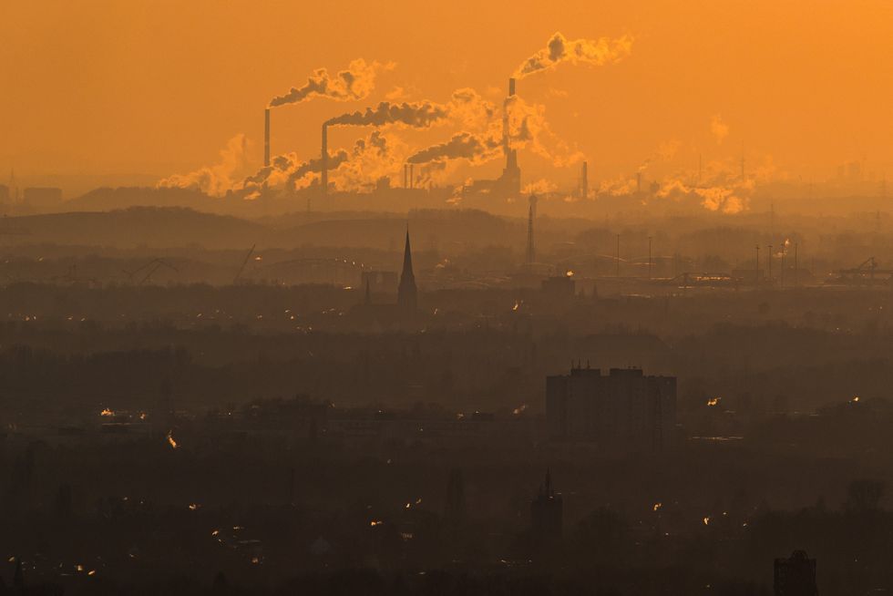 Steam and exhaust rise from different companies on a cold winter day