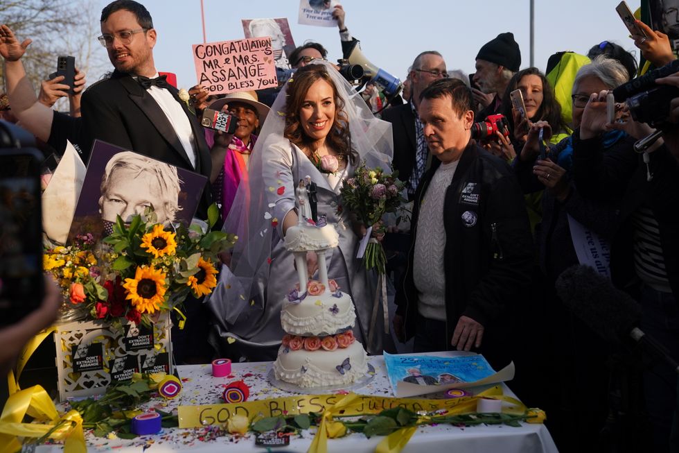 Stella Moris cuts a wedding cake outside HMP Belmarsh, south east London, after her wedding ceremony inside the jail to WikiLeaks founder Julian Assange where he has been held for three years. Picture date: Wednesday March 23, 2022.