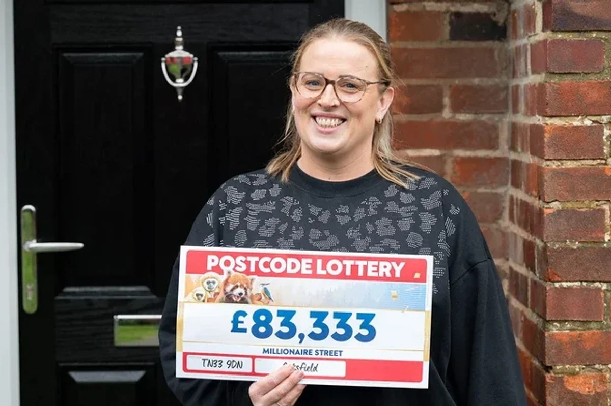 Steph Godfrey holding postcode lottery cheque