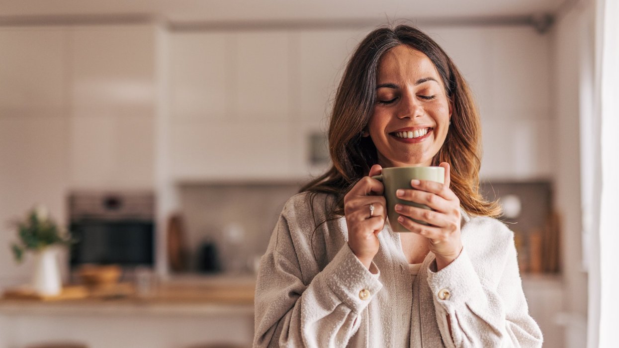 Stock image of a woman holding a cup of coffee