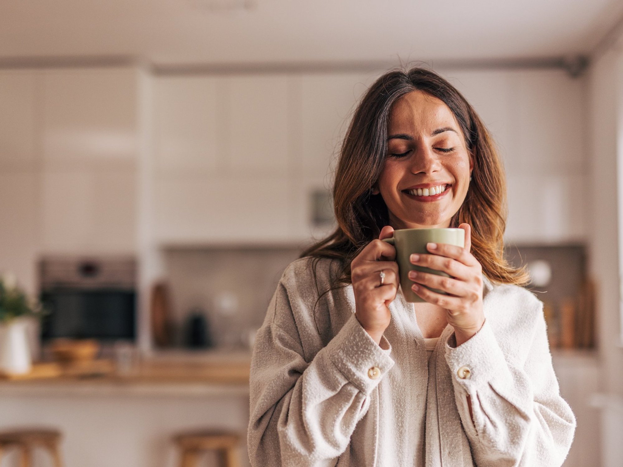 Stock image of a woman holding a cup of coffee