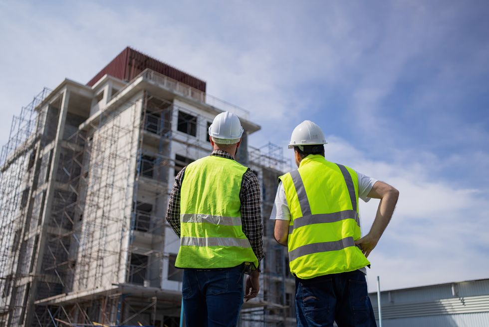 Stock image of builders working on a site