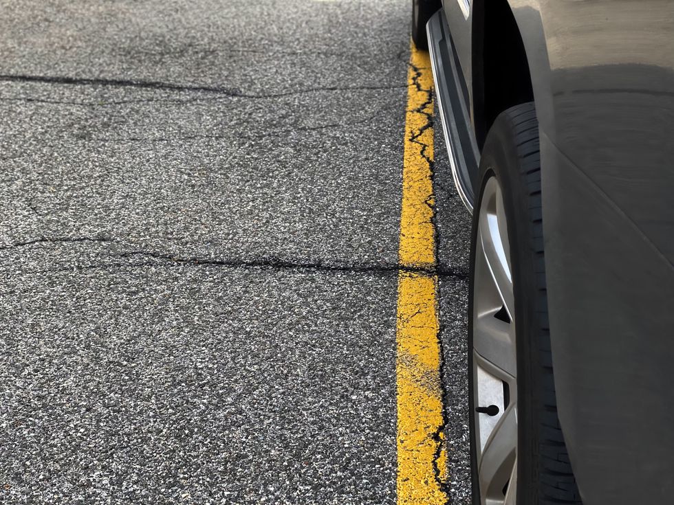 Stock image of car parked over line