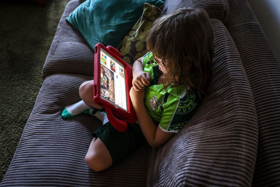 Stock image of child watching tablet