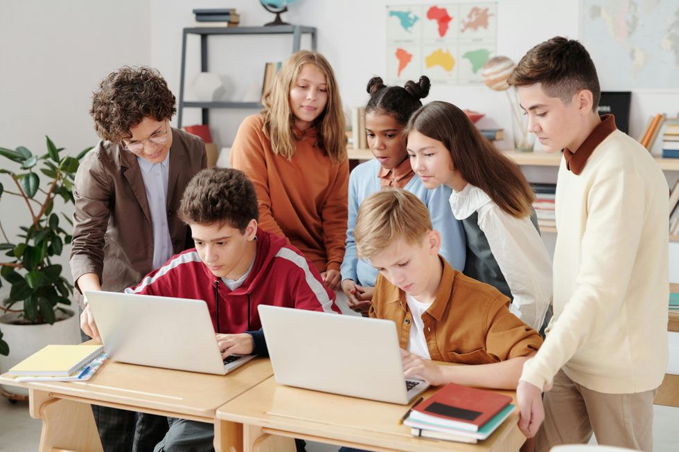 Stock image of children using laptops at school