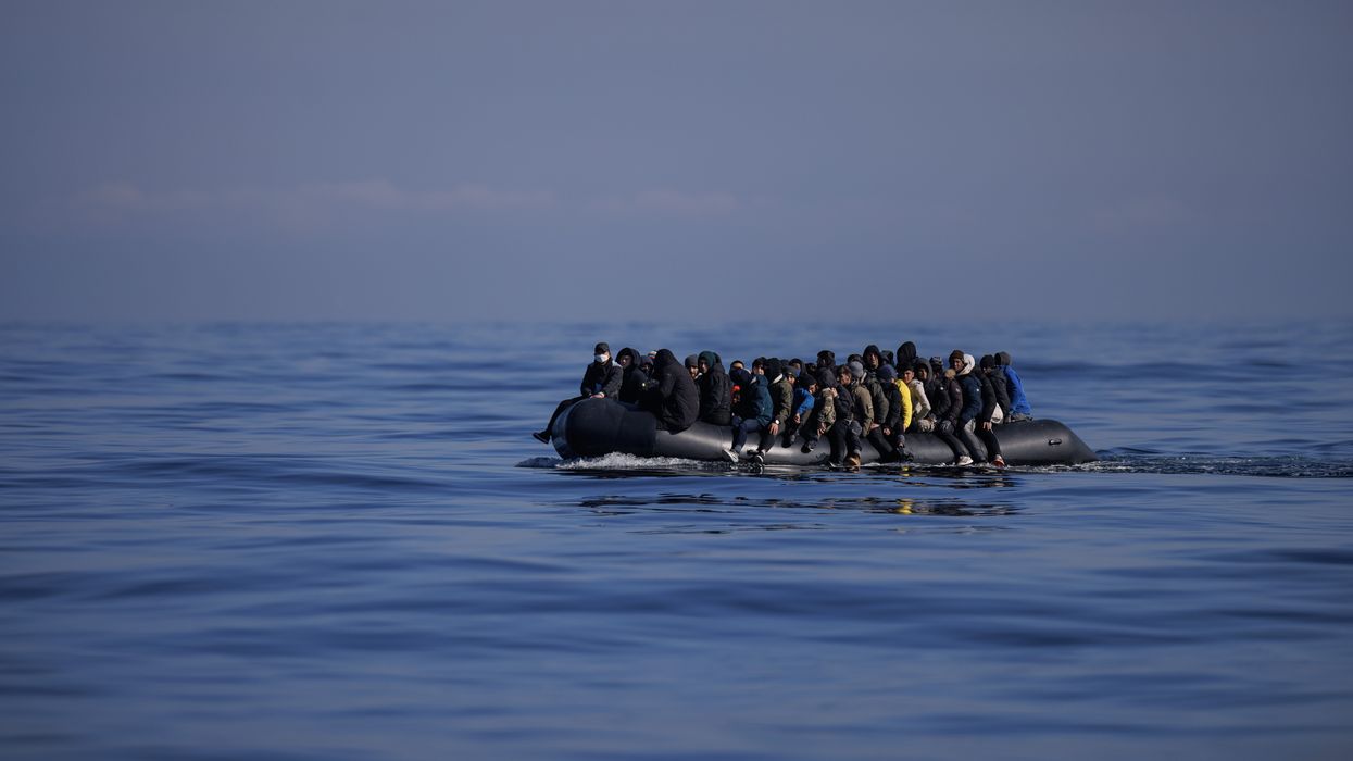 Stock image of migrants aboard a dinghy