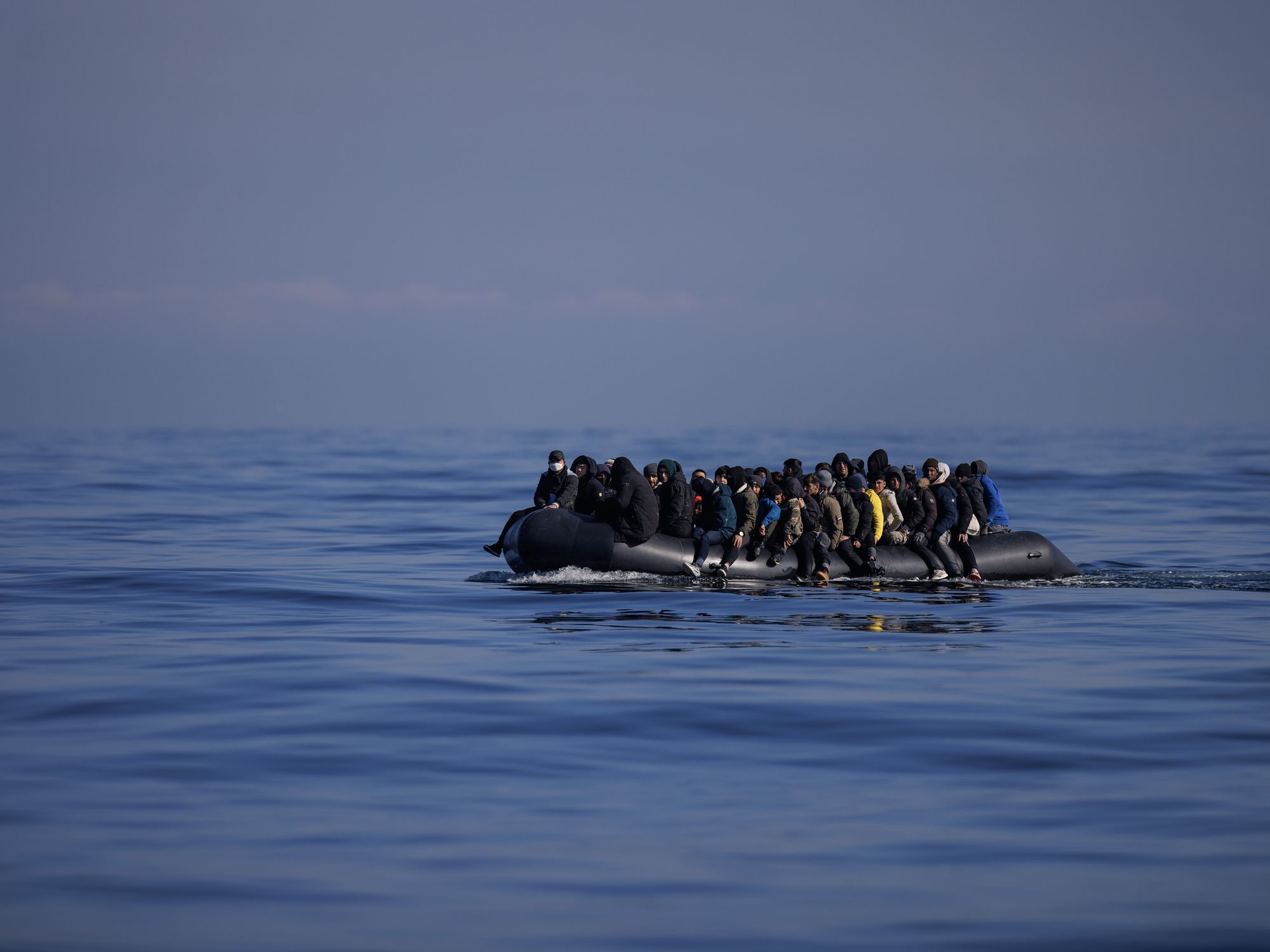 Stock image of migrants aboard a dinghy