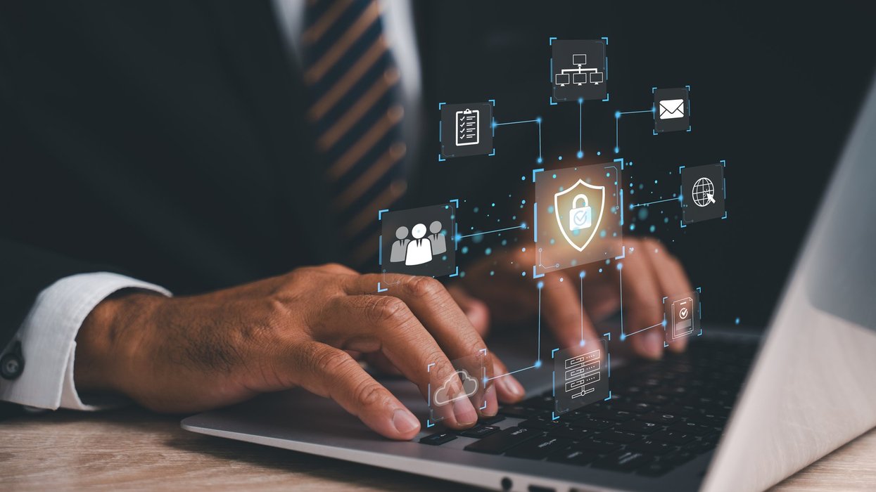 Stock image of person typing on laptop with a VPN symbol displayed