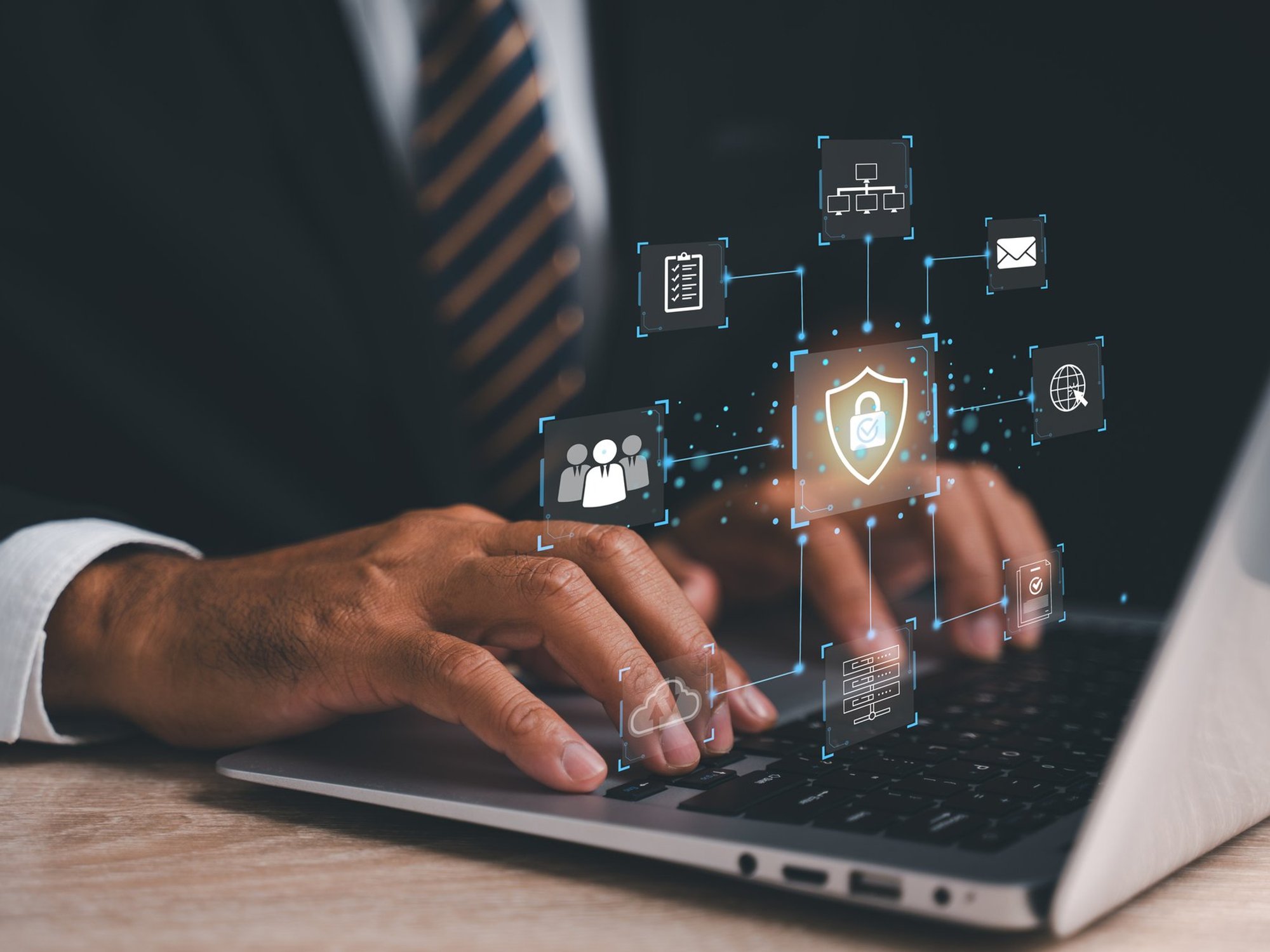 Stock image of person typing on laptop with a VPN symbol displayed