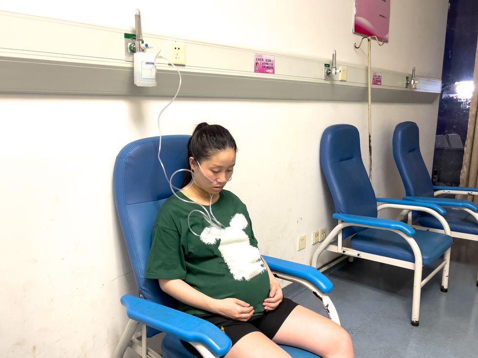 Stock image of pregnant woman receiving oxygen while in her third trimester