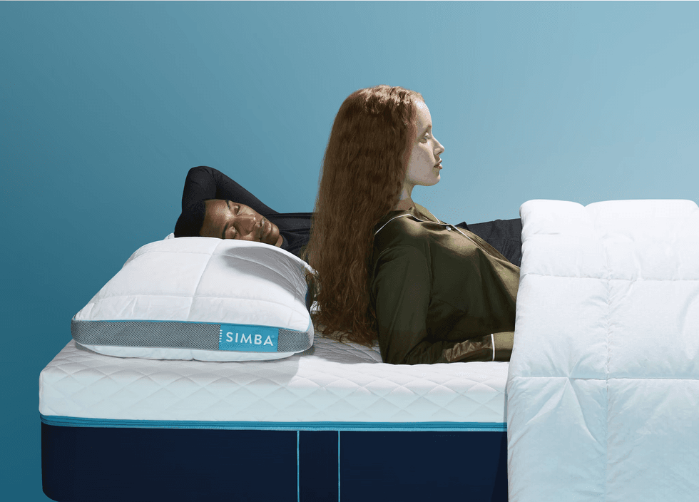 Stock image of two people lying on a Simba mattress and pillow