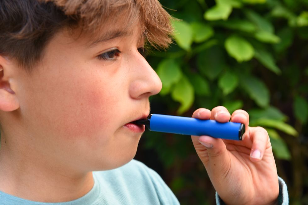 Stock image of young child vaping