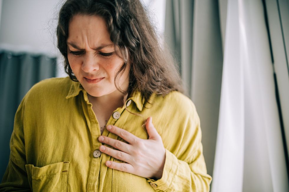STOCK IMAGE WOMAN WITH CHEST PAIN