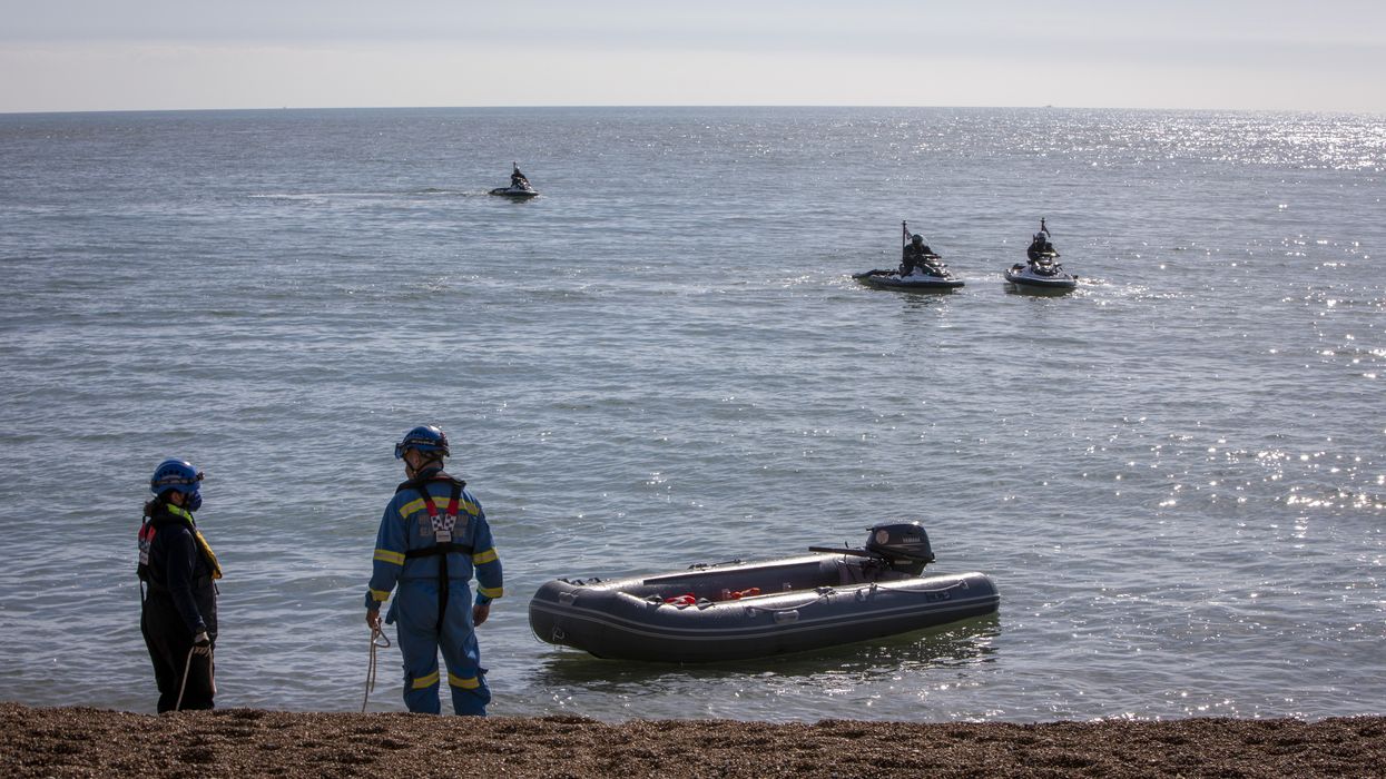 Stock image - workers remove small boat