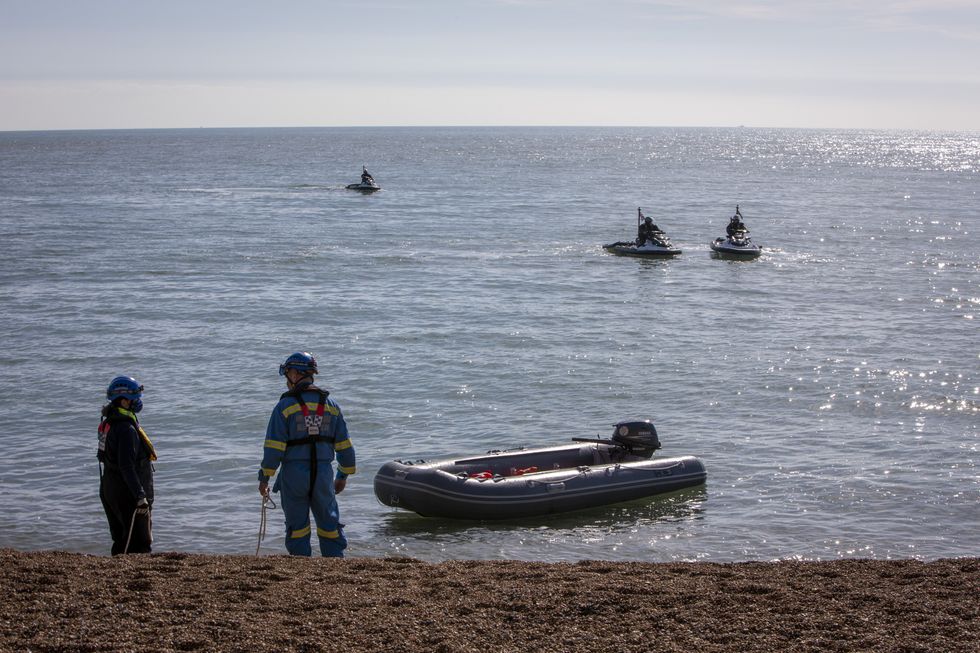 Stock image - workers remove small boat