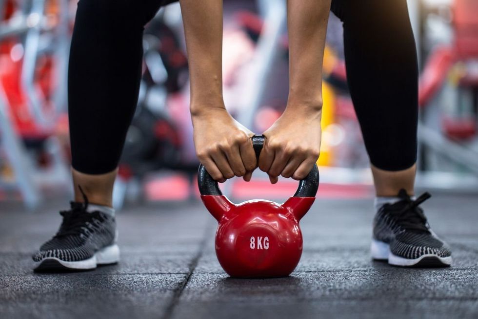 stock of woman lifting weights