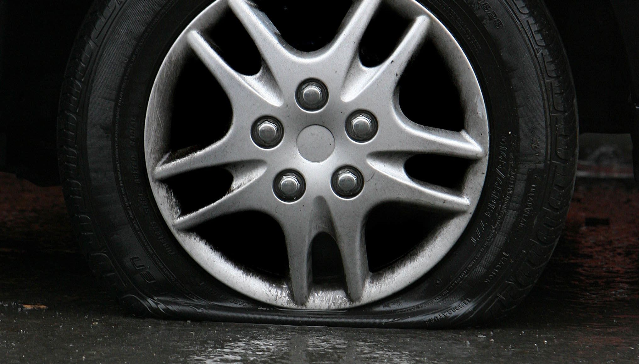 Stock photo of a flat car tyre.