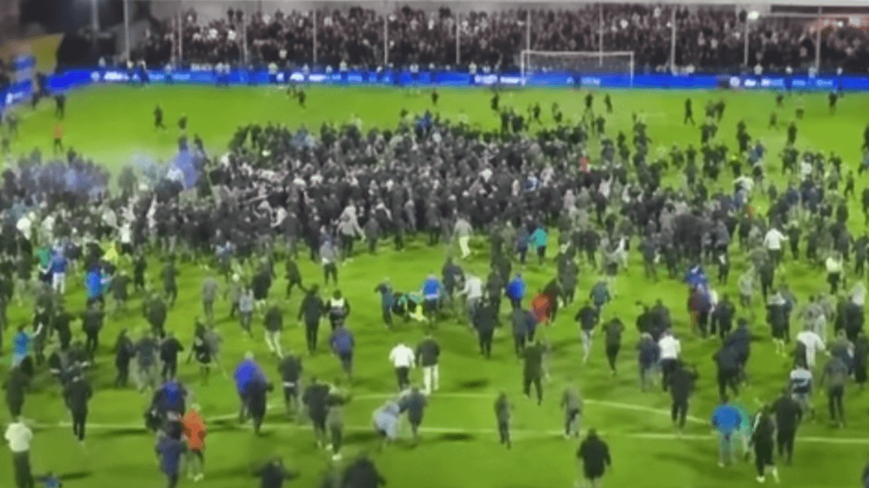 Stockport's celebrations after reaching the League One play-off final were marred by ugly scenes as Stevenage goalkeeper Filip Marschall appeared to be knocked to the ground during a pitch invasion at Edgeley Park