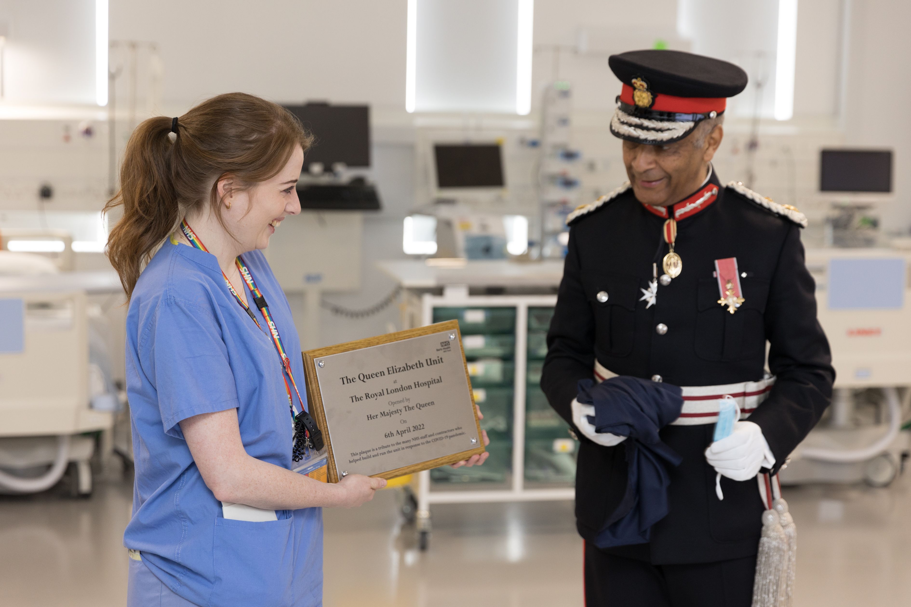 STRICTLY EMBARGOED UNTIL 2200HRS BST, SUNDAY 10TH APRIL 2022 Handout photo issued by Buckingham Palace of Sir Kenneth Olisa, Lord Lieutenant of Greater London (right) and Charlie Mort, Junior Sister, unveiling a plaque on Her Majesty's behalf during a video link call and virtual visit by Queen Elizabeth II to the Royal London Hospital on Wednesday to mark the official opening of the hospital's Queen Elizabeth Unit. Issue date: Sunday April 10, 2022.