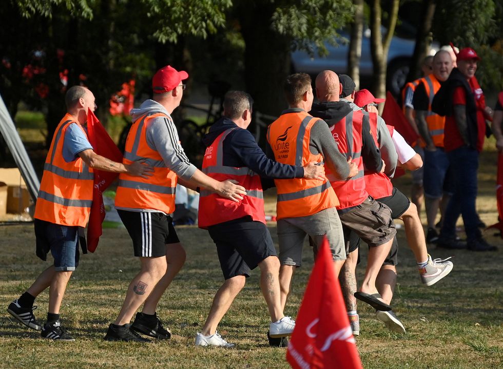 Strikers dance whilst protesting near an entrance to the UK's biggest container port Felixstowe, as workers continue an 8-day strike, in Felixstowe, Britain, August 22, 2022. REUTERS/Toby Melville