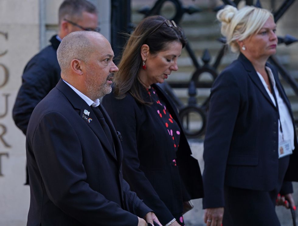 Stuart and Amanda (centre) Stephens outside Reading Crown Court ahead of the sentencing of two 14-year-old boys who were found guilty of murdering their 13-year-old son Olly Stephens.