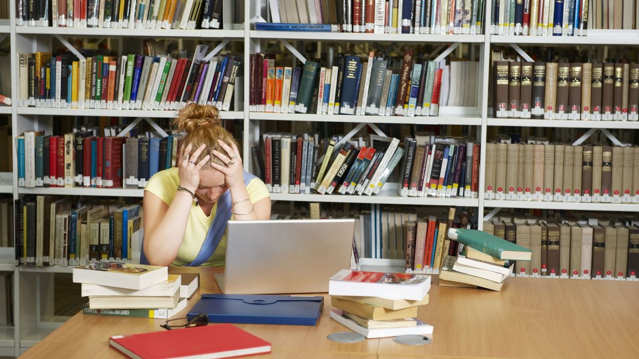 Student with books in library