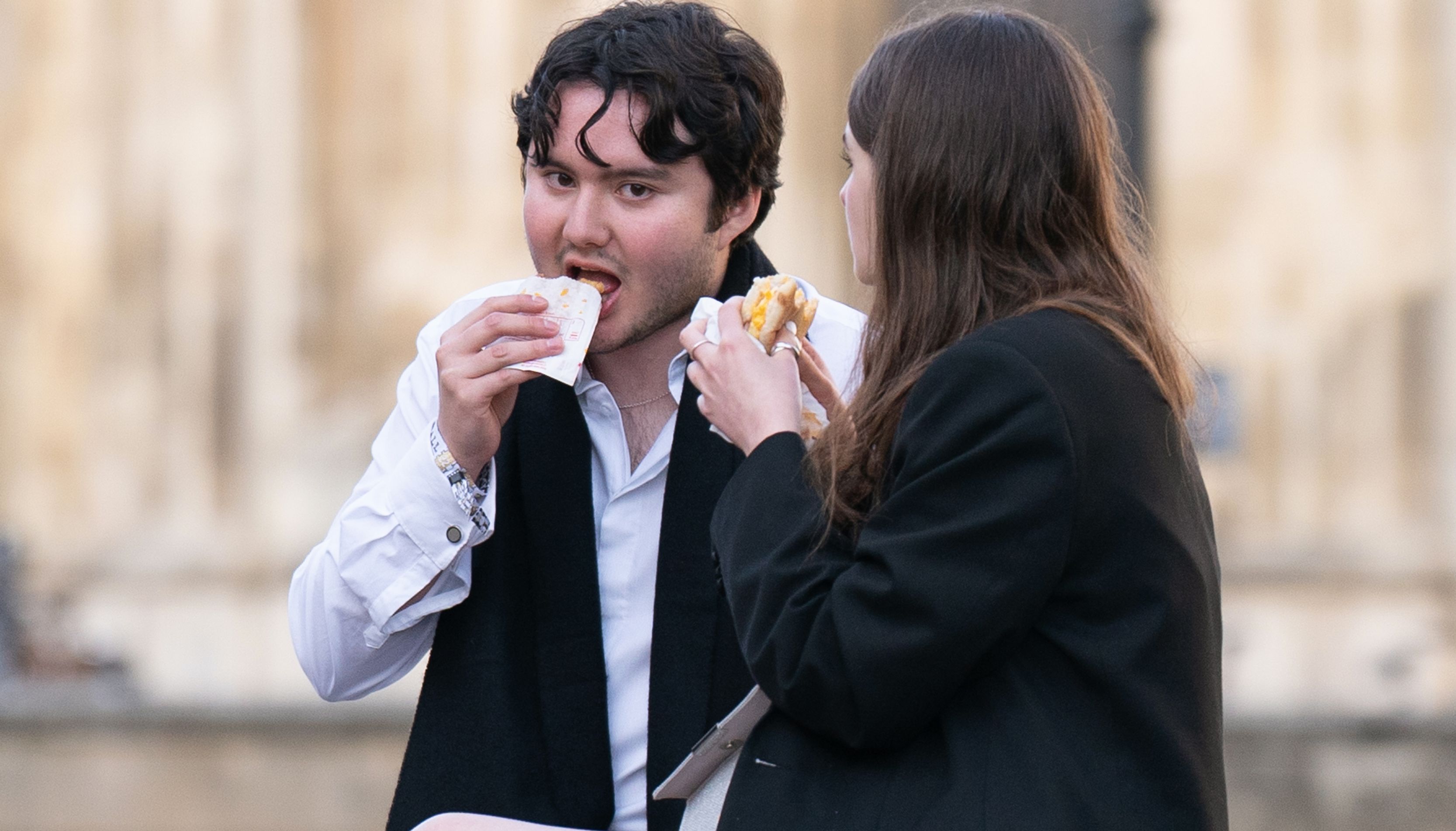 Students from Cambridge University make their way home after celebrating the end of the academic year at a May Ball in Trinity College. Picture date: Tuesday June 21, 2022.