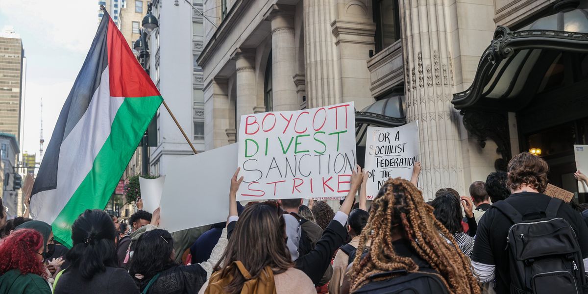 NextImg:Anti-Israeli protesters burn US flag as they accuse Biden of 'genocide'