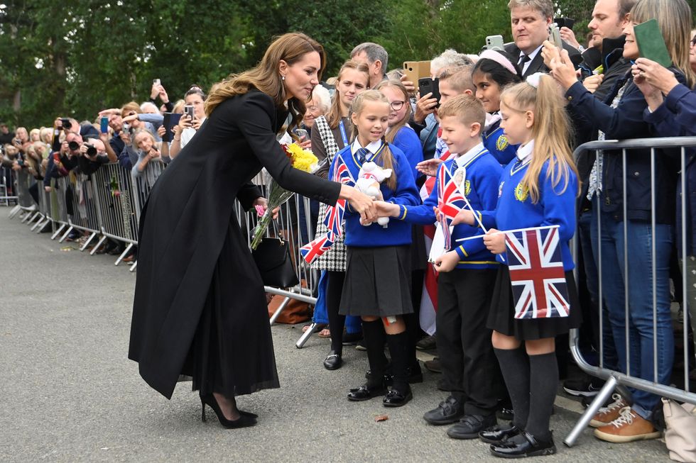 Students from Howard Junior School in King's Lynn greet Britain's Catherine, Princess of Wales, as she meets people gathered outside Sandringham Estate, following the death of Britain's Queen Elizabeth, in eastern England, Britain, September 15, 2022. REUTERS/Toby Melville/Pool