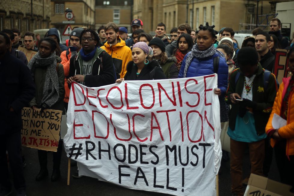 Students march through Oxford, as they call for the removal of a statue mounted on Oriel college building of British imperialist Cecil Rhodes.