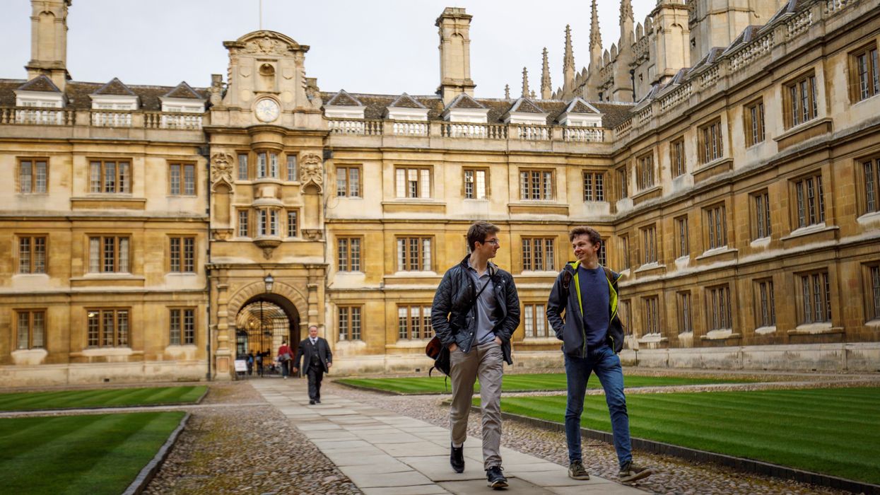 Students walk through Cambridge University in Cambridge
