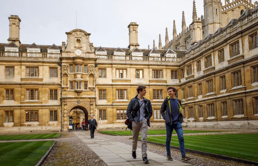 Students walk through Cambridge University in Cambridge