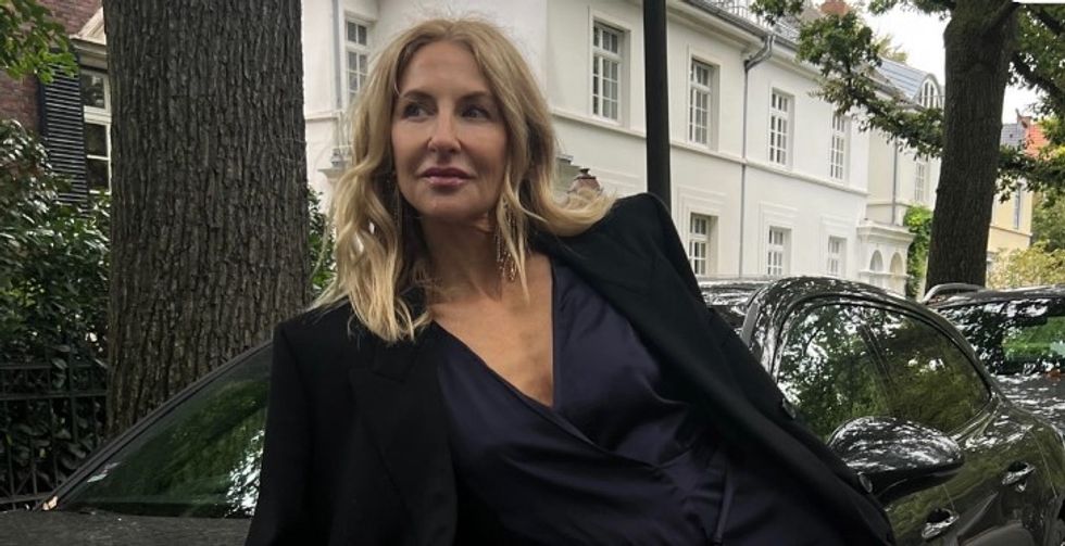 Sue leaning against car